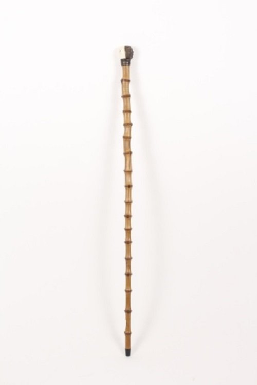 Carved Bone & Bamboo Cane w/Double Headed Monkey: Antique bamboo walking stick or cane with carved bone animal accent at top with double headed monkey with white monkey face with brown glass eyes on one side, opposite side with brown monkey or ape fa