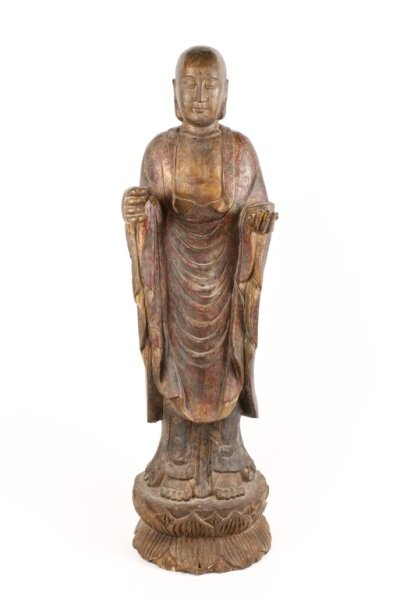 19th C. Carved & Polychromed Wood Buddha Sculpture: Chinese, 19th century, possibly earlier. Hand carved and polychromed wooden figural sculpture depicting Buddha standing barefoot at full length with bald head, elongated earlobes, calm and peaceful fa