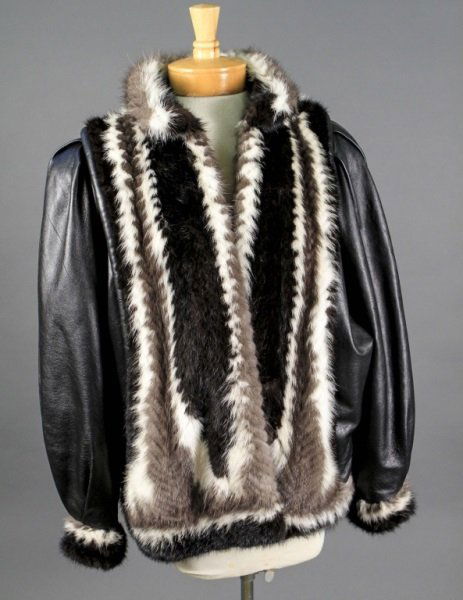 Vintage Cosmopolitan Mink and Lambskin Jacket: Vintage Cosmopolitan tri-colored mink and lambskin jacket, the body of the jacket covered in gray-brown, white and black mink with lambskin arms ending in mink cuffs. The shell stamped throughout 'Gei