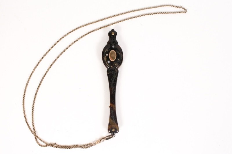Pair of Ladies Tortoiseshell & MOP Lorgnettes: Late 19th/Early 20th century. Pair of lorgnettes finely engraved with scrolled foliates and accented with mother of pearl flowers and ornament throughout case, small oval medallion on one side for mon