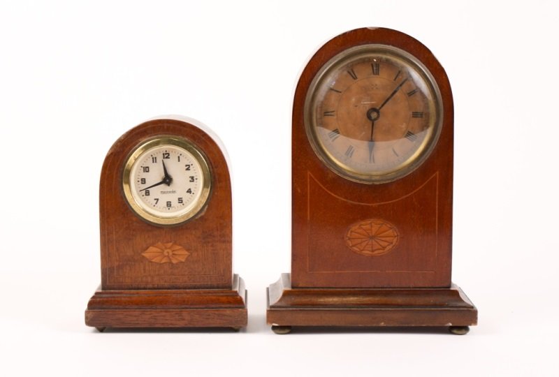 Pair of German Inlaid Mantle Clocks: Pair of 20th Century German inlaid mantle clocks, both dome form with satinwood inlay sehll, one stamped to the dial Mercedes for GebrÃ¼der Hauser, the other with crossed swords for Hamburg Amerikan
