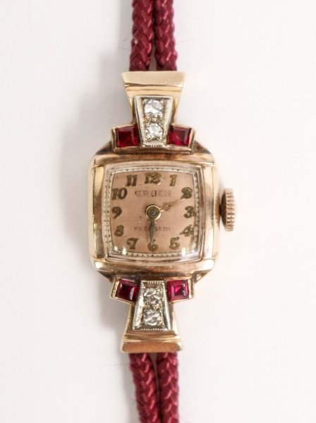 Ladies 14k Gold Watch w/ Rubies & Diamonds: Circa 1940s, ladies vintage Gruen Precision 14k pink gold and white gold wristwatch with copper colored dial accented with four synthetic rubies and four natural single cut diamonds. Watch with burgun