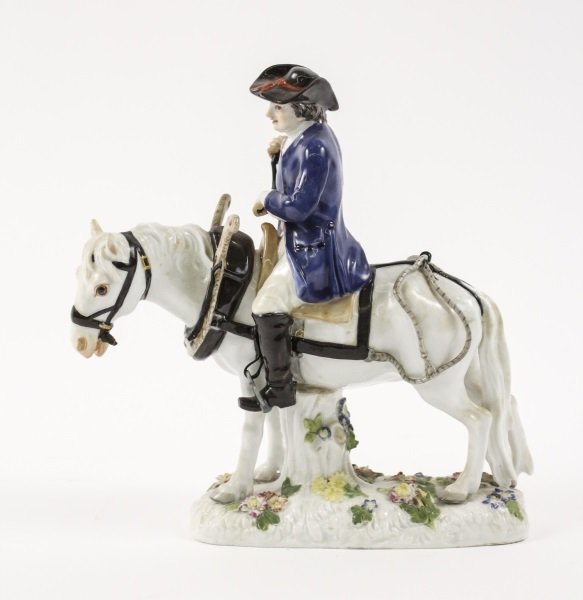 Meissen Figurine, Male Plowman on Horseback: German, late 19th/ early 20th century. A Meissen porcelain figurine, circa 1815-1923, depicting a male farmer in blue coat, red striped vest, and black hat on horseback, with plow harness around the w