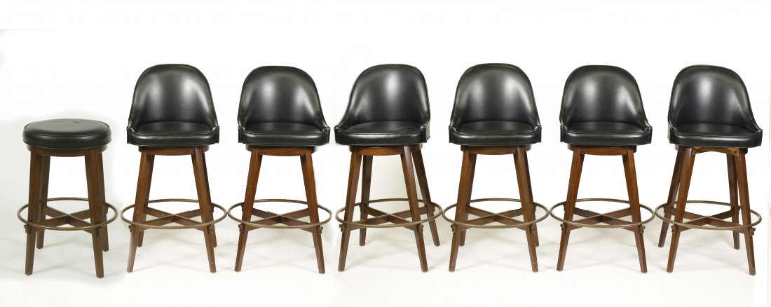 Set of 7 Custom Built Mahogany Swivel Bar Chairs: Philippines, circa 1965. Set of 7 custom built mahogany & black leather covered swiveled bar chairs or stools, 6 with shaped back on four outswept square tapered legs united by a cross stretcher and m