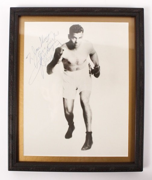Framed Autographed Photo of Boxer Jack Dempsey: Framed black and white promotional photograph of noted iconic boxer William Harrison "Jack" Dempsey (American, 1895-1983), also known as "Kid Blackie" and "The Manassa Mauler". Signed autograph in blu