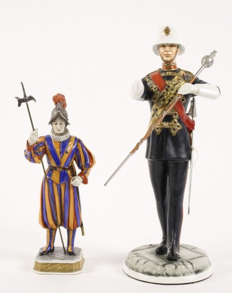 Group of 2 Porcelain Figurines of Uniformed Men: Collection of two porcelain figurines comprising of a Michael Sutty (English, 1937-2003) Model No. 174 "Drum Major Royal Marines 1978", approximate height 12.4"; and a Pontifical Swiss Guard in stripe