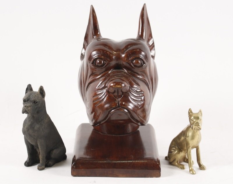 Collection of Three Dog Sculptures: Group of three unmatched dog sculptures comprising of a brass seated boxer; a heavy cast patinated bronze seated boxer; and a carved wood boxer head on wooden plinth. All unsigned. Height of brass dog