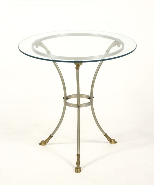 Louis XVI Style Gilt Bronze Gueridon: Louis XVI style gilt bronze and metal gueridon with circular glass top resting on 3 gilt bronze ram's head monopodia supports joined by circular stretcher on gilt bronze hoof feet. Height 26", diamete