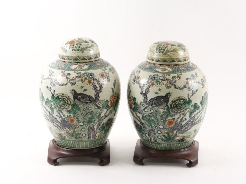 Pair of Large 19th C. Japanese Ginger Jars: Japanese, 19th century. A pair of porcelain lidded ginger jars with finely composed hand painted opposing decoration of chrysanthemum flowering branches growing off a craggy rock, a purple and grey bi