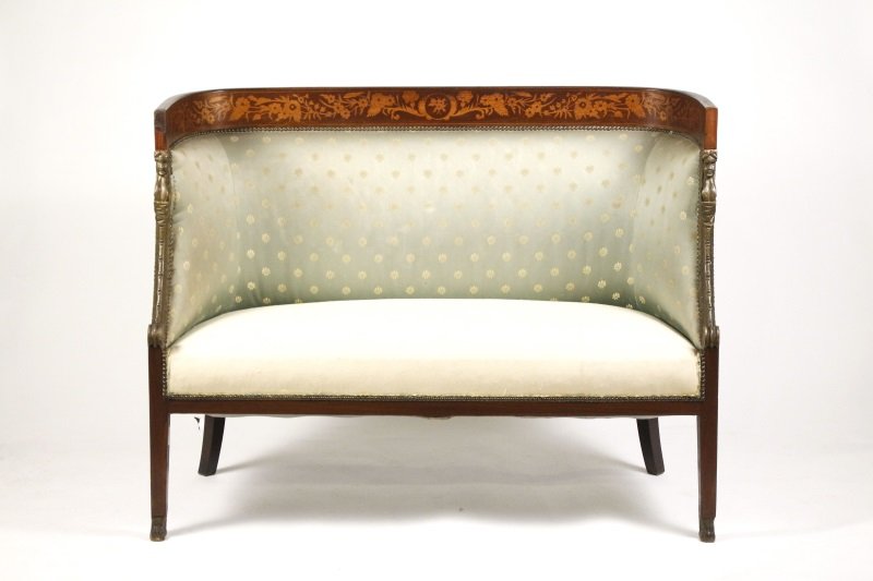 Empire Style Mahogany & Marquetry Inlaid Settee: Italian, circa 1870s. Empire style marquetry inlaid mahogany settee or canape with rounded shaped and padded back inlaid with scrolling floral marquetry with downswept caryatid scrolled terminals rais