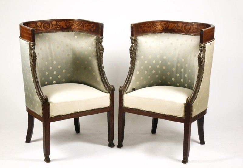 Pair of Empire Style Marquetry Inlaid Armchairs: Italian, circa 1870s. Matched pair of Empire style marquetry inlaid mahogany bergere or armchairs, both with rounded shaped and padded back inlaid with scrolling floral marquetry with downswept caryat