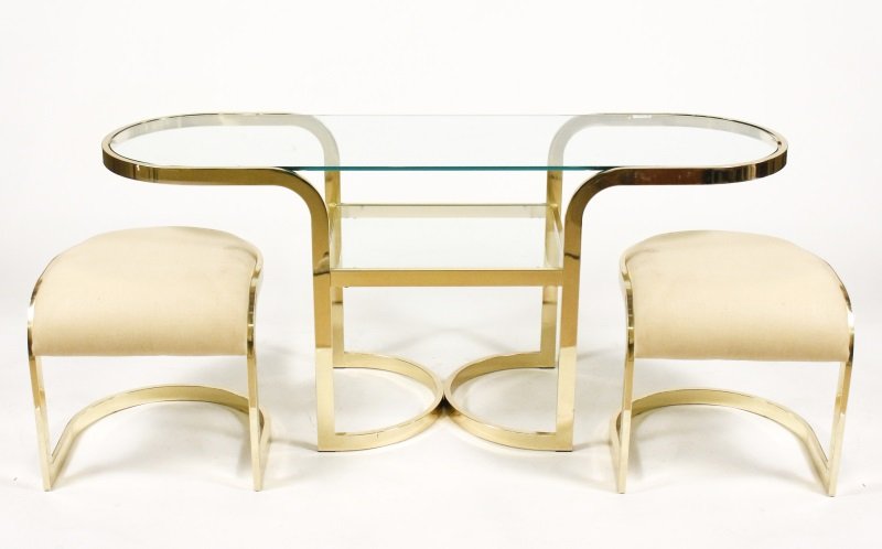 3 Pc Brass Milo Baughman Style Table & 2 Stools: America, 20th century. Design Institute of American matched 3 piece brass set in the manner of Milo Baughman comprised of a console table with 2 stools. The table with oval glass top within continuous