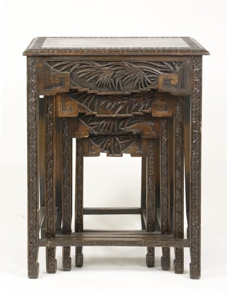 Chinese Nest of 4 Stained Wood Tables: Chinese, early 20th century. Chinese nest of four stained wood tables, graduated in size, the rectangular top with a rosette carved border and leafy edge over an apron carved with bamboo leaves and me