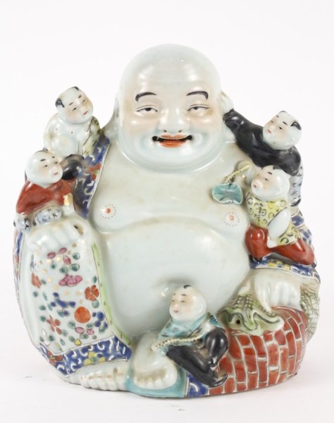 Japanese Porcelain Figural Group, Hotei: Japanese, 20th century. Porcelain figural group depicting a large happy Buddha figure (hotei) with bald head, rosy cheeks and smiling facial expression wearing and floral patterned loose robe showing 