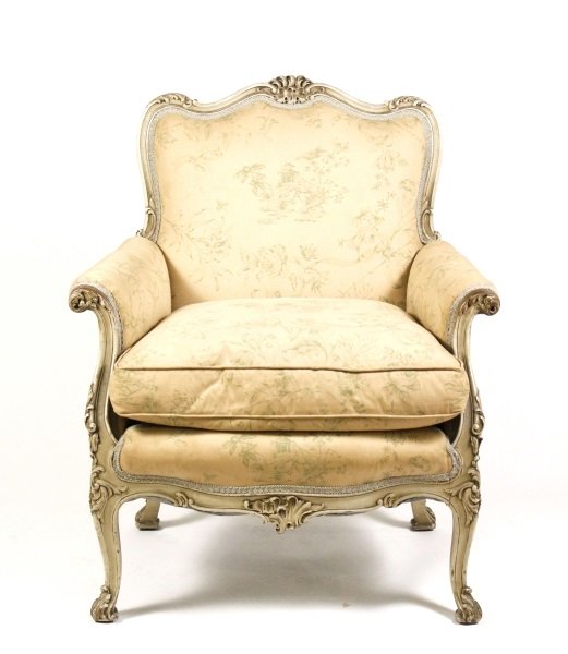 Louis XV Style Paint Decorated Bergere Chair: Continental, circa 1930s. Louis XV style paint decorated bergere or closed armchair with serpentine crestrail carved with foliage over a padded back, sides and seat with removable cushion above a simi