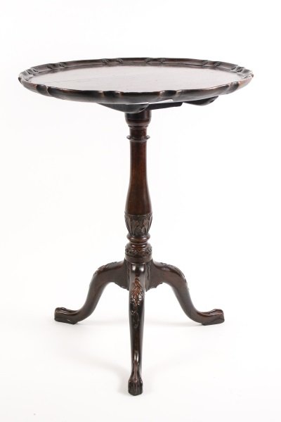 18th C Mahogany Tilt Top Tripod Table: 18th century mahogany carved tilt top table with pie crust top raised on vasiform turned standard carved with leafy foliage on a tripod base carved at the knee with foliage and terminating in rat's pa