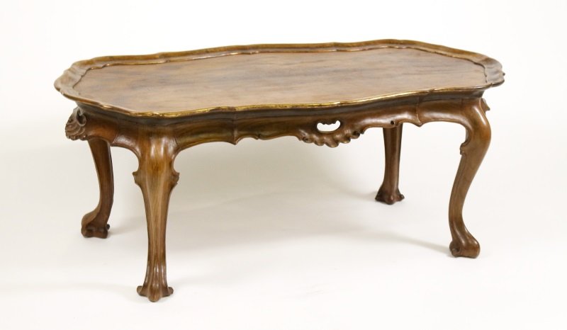 Spanish Rococo Style Olive Wood Coffee Table: Spanish, circa 1940s. Spanish Rococo style olivewood and parcel gilt coffee, cocktail or low table with shaped dished parcel gilt top over a conforming pierced apron raised on cabriole legs terminatin