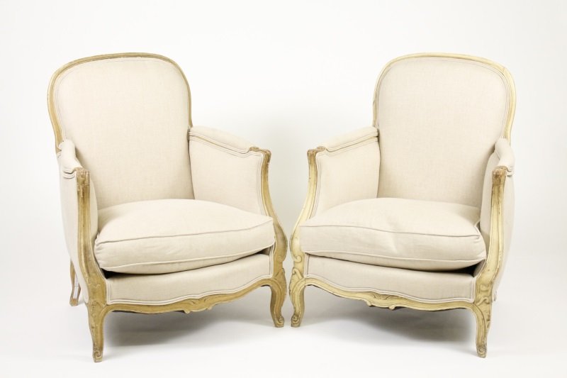 Pair of French Painted Diminutive Bergere Chairs: Matched pair of 20th century French diminutive upholstered bergere chairs with curving back and arms paint decorated in cream with loose cushion seat raised on squat cabriole legs. Height 32.25", widt