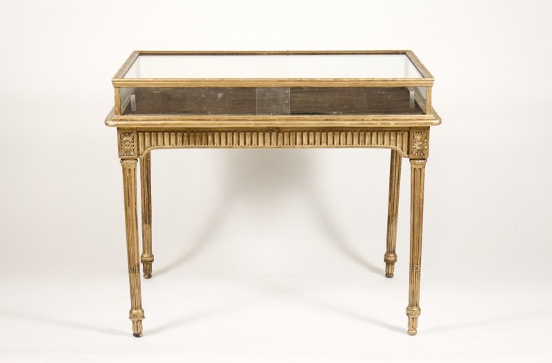 French Louis XVI Style Giltwood Vitrine Table: French, early 20th century. Louis XVI style giltwood vitrine or display table, the top and sides mounted with glazed panels, the 2 long sides of the case having sliding glass for interior access over 