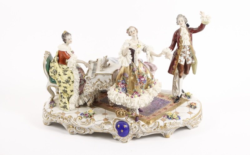 16" Dresden Lace Volkstedt Figural Grouping, Piano: Volkstedt Porcelain (Germany, 1760- ). A late 19th/ early 20th century large "Dresden Lace" porcelain figural grouping comprising of three figures in 18th century dress with porcelain lace decoration,