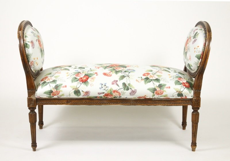 Louis XVI Style Floral Upholstered Window Bench: 20th century Louis XVI style window seat or bench with padded rectangular seat flanked to either side by padded oval medallion arm rests within a guilloche carved and beaded surround, the whole uphols