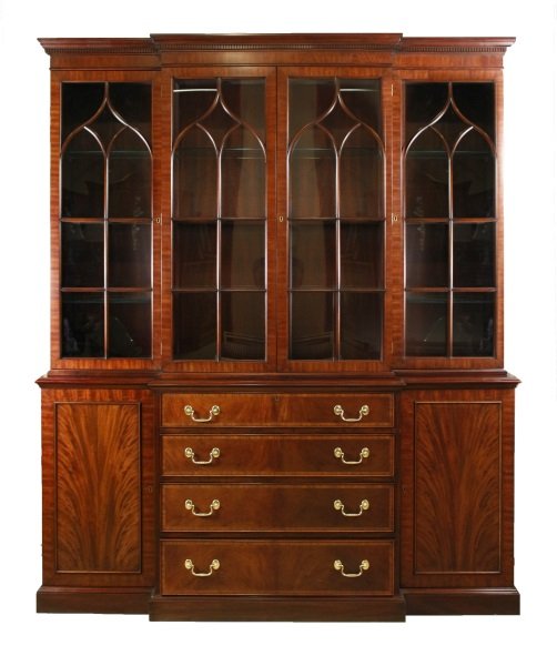 Henkel Harris Mahogany Breakfront China Cabinet: American, 20th century. Henkel Harris mahogany china cabinet, the breakfront pediment over a conforming case with dentil molded cornice and four astragal glazed doors with glass shelved and lighted in