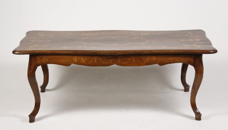 Louis XV Style Marquetry Inlaid Walnut Low Table: Italy, early 19th century. Louis XV style marquetry inlaid walnut low or coffee table, the molded edge top of serpentine form inlaid with fruitwood over a conforming inlaid shaped apron, raised on cur