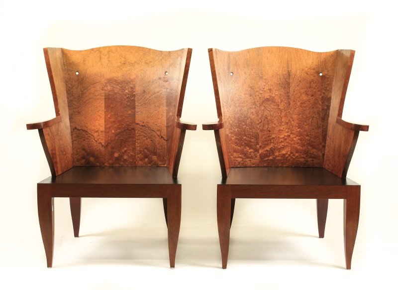 Pair of French Deco Style Wood Wingback Chairs: 20th century. Matched pair of French Deco style modern wingback burled walnut finish wood chairs with minimal camel back flaked by tapered wing sides, scrolled arms, two pierced holes in back (likely