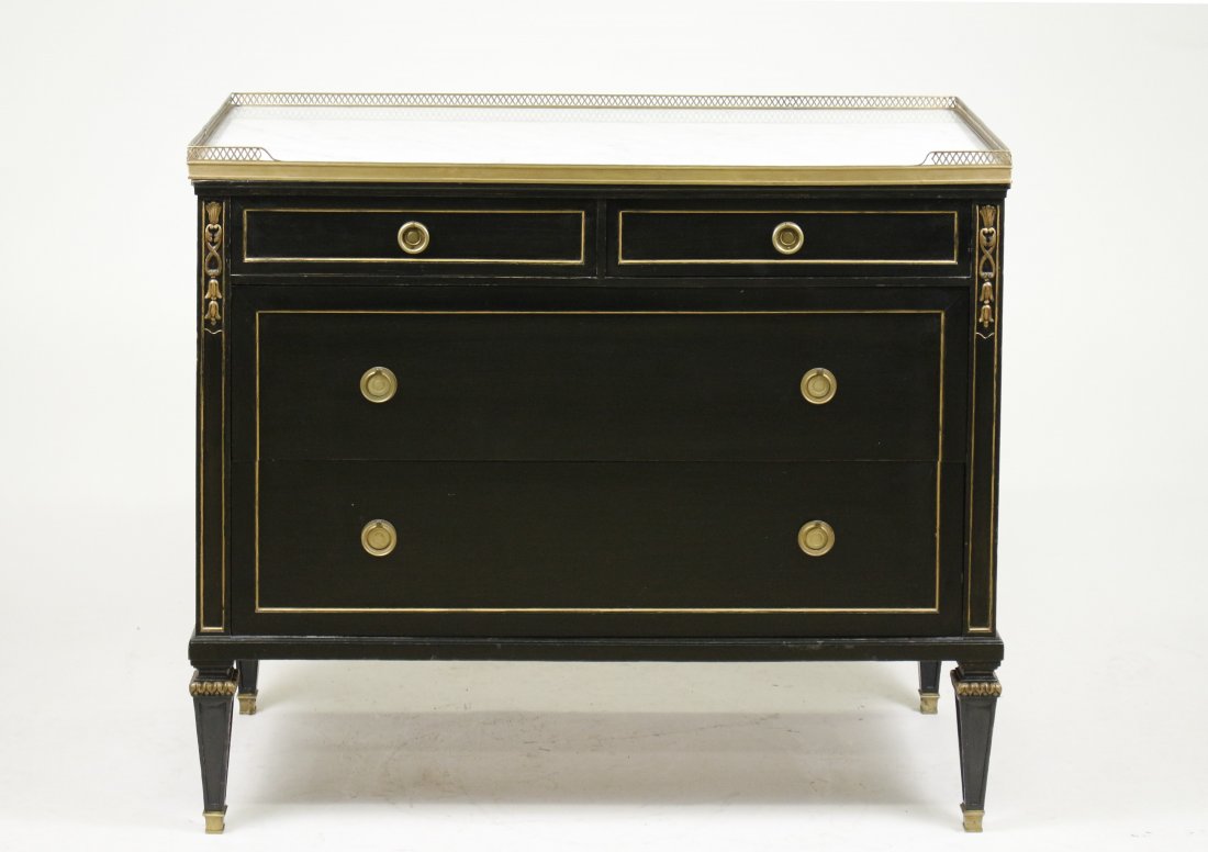 Jansen Black-Lacquered Directoire Style Commode: French, circa 1950's. Maison Jansen Directoire style bronze mounted and black lacquered and parcel gilt decorated commode or chest of drawers, having a white marble top contained within a three quarte