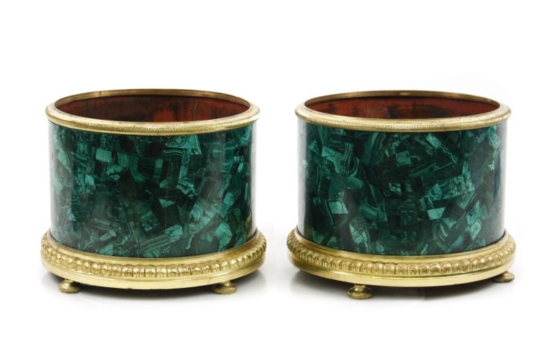 Pair of Empire Style Malachite Jardinieres: 20th century. Pair of Empire style gilt bronze and malachite veneered jardiniere planters of cylindrical form with arched border at bottom and twisted texture on top banding. Elegant jardiniere plante