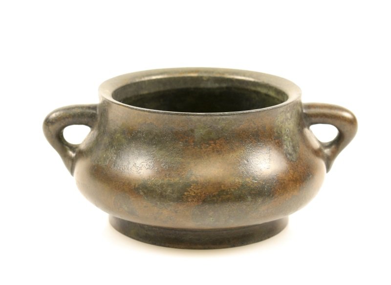 Chinese Xuande Style Bronze Censor, Marked: Chinese, Ming Dynasty Xuande Period mark (1425-1435) but dating to a later period. A cast bronze footed censer of bulbous form with tapered neck having triangular handles to either side and round foot