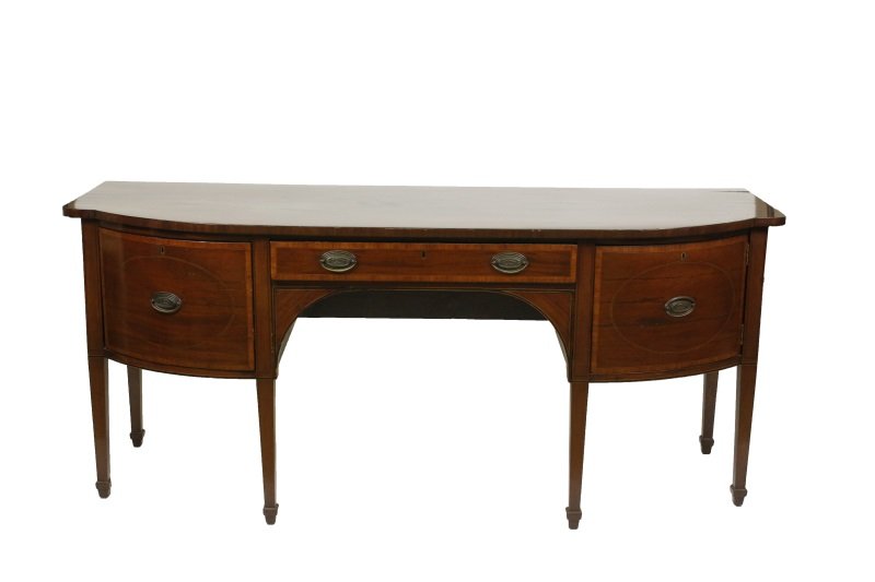 George III Hepplewhite Mahogany Sideboard: English, Late 18th century. George III Hepplewhite mahogany inlaid sideboard, the shaped rectangular top with bow front, above a single drawer flanked to one side by a deep cellarette, the other side 