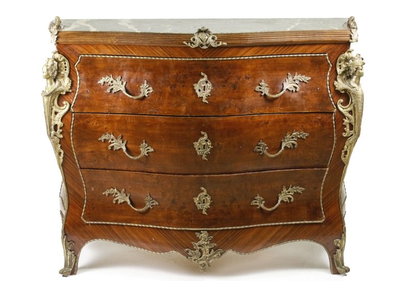 French Mahogany Marble Top Ormolu Mounted Commode: French, 20th century. Louis XV style bombe three drawer commode with serpentine inset green marble top with reeded border accented by shell and scrolled foliate ormolu mounts above three pull out draw