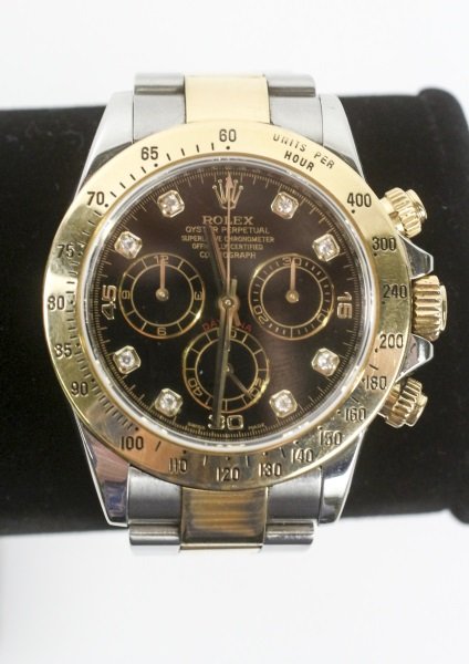 Men's 18k Gold & Diamond Daytona Watch: Men's Rolex Oyster Perpetual Cosmograph Daytona watch with 18k yellow gold case with black face accented with diamonds with three subdials, two tone bracelet band.