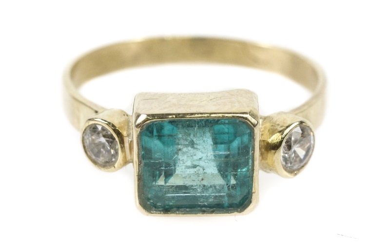 Ladies 10k Gold & Emerald Ring: Ladies 10k yellow gold, emerald and cubic zirconia ring with a central bezel set rectangular enhanced emerald (approximately 1.47 carats total weight, clarity: I1) accented on sides by cubic zirconias