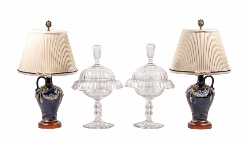 Pair of Crystal Sweetmeat Urns & 2 Majolica Lamps: Pair of majolica ewer form table lamps with glazed cobalt blue exteriors with lighter blue flowers resting on olive green ribboned swags above a wooden round socle foot, cream colored pleated fabric s