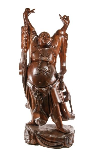 Monumental Carved Wood Happy Buddha Sculpture: Chinese, 20th century. Monumental carved and stained wood figural floor sculpture in the form of a Happy Buddha, Hotei, Pu-Tai, or Ho Tai, the laughing bald man cloaked in robes with a largely exposed