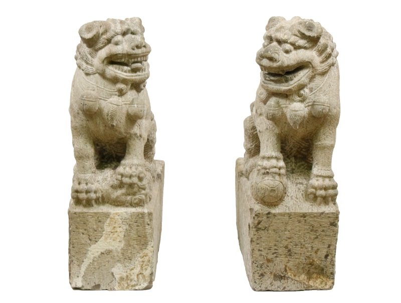 Pair of Large Chinese Carved Limestone Shishi: Chinese, early 19th century. Pair of palatial size Chinese limestone Buddhist guardian lions, Shishi or Foo Dogs, each opposing figure well carved seated on its haunches, one with foreleg grasping at