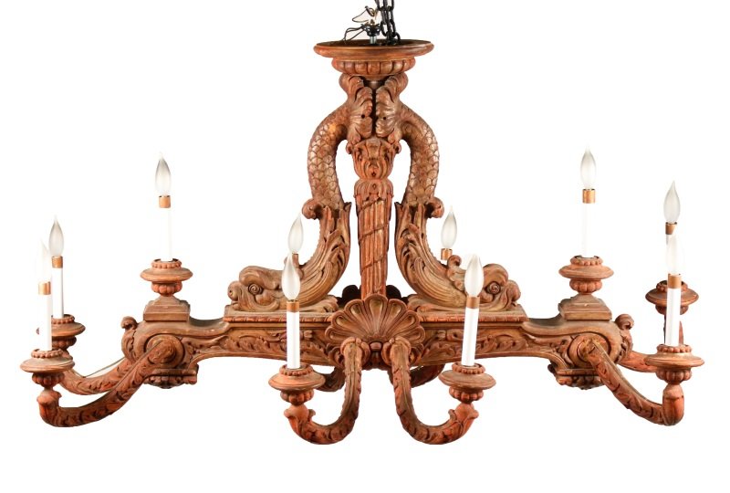 Continental School, 10 Arm Chandelier w/Dolphins: Continental School, Early 20th century. Carved giltwood ten arm chandelier with weathered patina exposing reddish tone on wood throughout with remnants of gilt. Chandelier later electrified with lamps