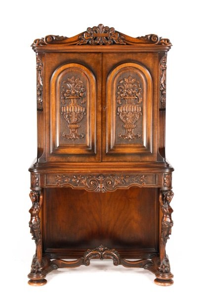 Renaissance Revival Style Walnut Cabinet: Early 20th century Renaissance Revival style walnut cabinet, the rectangular molded cornice with a scrolled pediment carved with putti flanking a fleur de lis, above two doors carved with vases issuin