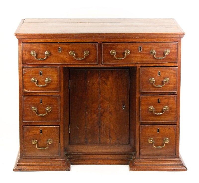 George II Mahogany Kneehole Desk, English, 18th C: English, 18th century. George II mahogany wood kneehole desk with rectangular top above drawered storage with brass bail pulls and escutcheons with two pull out drawers at top above sides with three s
