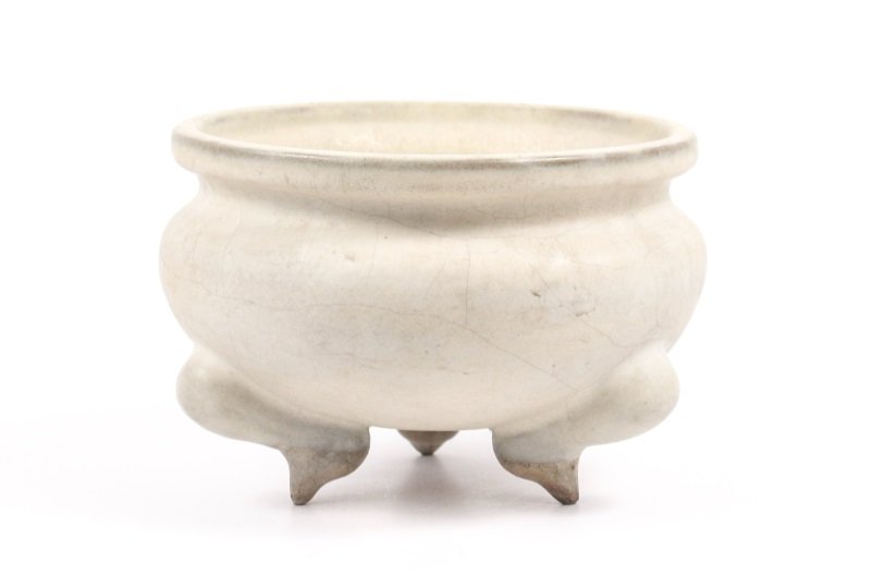 Chinese Shang Dynasty Style White Stoneware Censer: Chinese, likely 19th century Qing Dynasty but possibly earlier. A Shang Dynasty style tripod footed censer of white stoneware, the censer of compressed bulbous form with incurvate neck and rounded lip