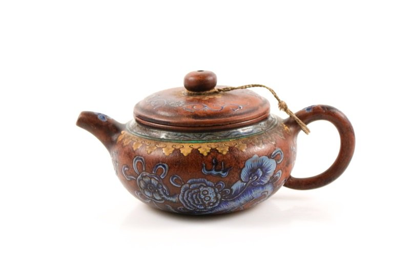 Polychromed Yixing Zisha Teapot w/ Flowers, Marked: Chinese, 20th century. A Yixing Zisha teapot of round form with hand painted enamel decoration on tondo to side wall depicting dragons and flowers below patterned bands to shoulder and neck, the pot w
