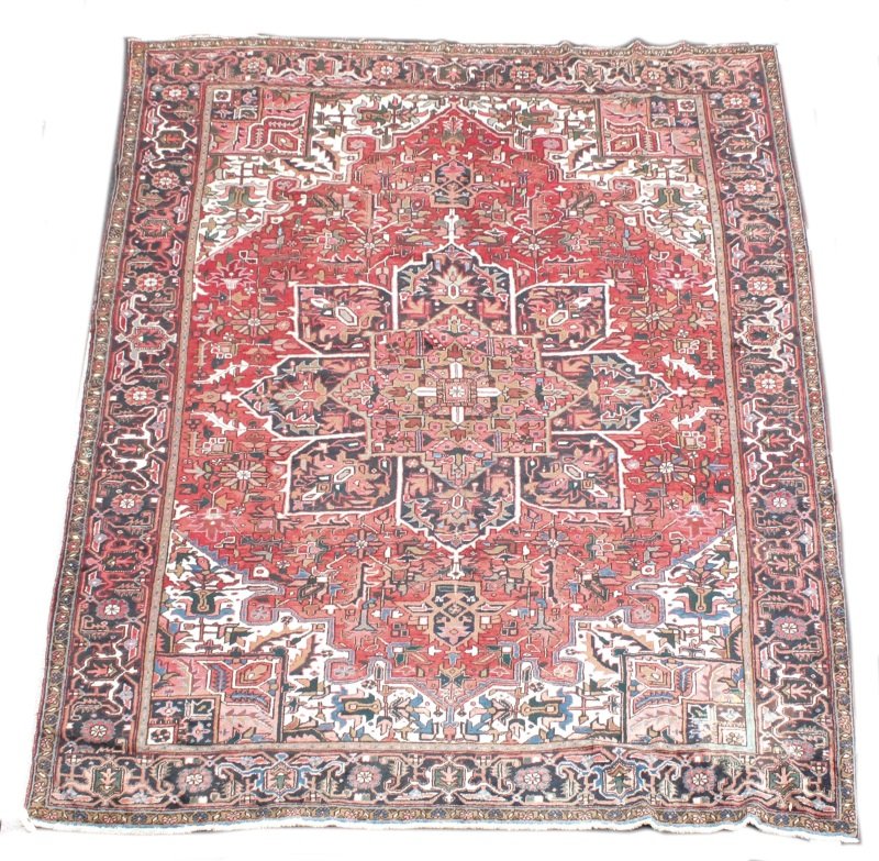 Hand Woven Persian Heriz ( 9' 10" x 13' 5" ): Wool. Iran. Floral and geometric design on burgundy field. Red, cream, gold, rust and brown accent colors. measures approximately 9' 10" x 13' 5"