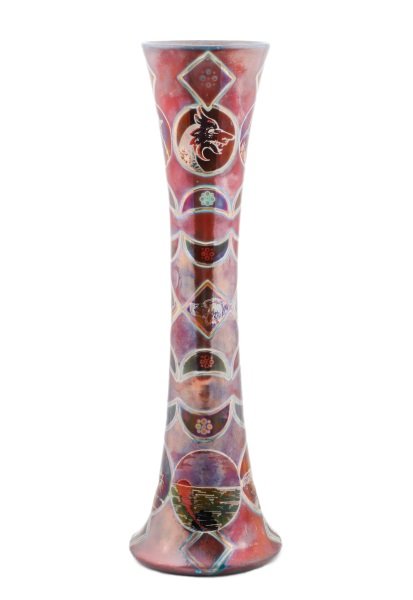 Vallauris Iridized Pottery Vase, Jerome Massier: Jerome Massier (French, b.1850). A Vallauris iridized pottery vase of elongated flask form decorated with line drawings of crescent moons, circles, and diamond patterns, some surrounding depictions of