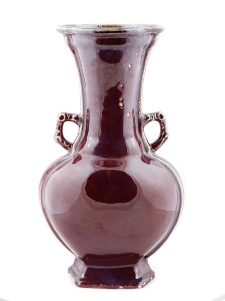 Chinese Ox Blood Flask Vase, Yongzheng Mark: Chinese, Qing Dynasty Yongzheng Period Mark (1722-1735), likely 20th century. A porcelain flask form vase with allover ox blood glaze thinned at rim, side ribs, and handles revealing white pottery ben