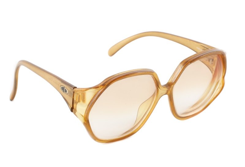 1970s Vintage Christian Dior Gold Glasses: Christian Dior (French, founded 1946). Vintage 1970s designer eyeglasses with metallic gold flecked amber yellow frames accented with CD on each temple in gold and black oval. Currently filled with pr