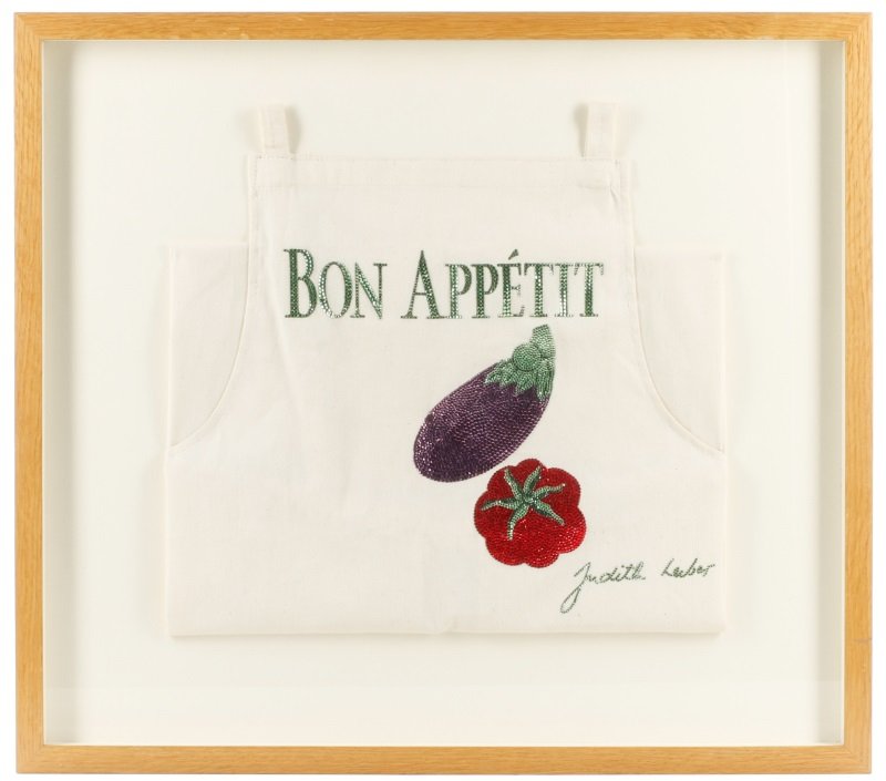 Framed Judith Leiber Apron for Bon Appetit: Judith Leiber (American, founded 1963). Designer one of a kind framed cook's or chef's white cotton apron decorated on front by Judith Leiber with "Bon Appetit" in green rhinestones (font matching tha