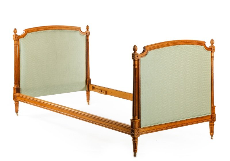 French Louis XVI Style Beechwood Daybed: French, 20th century. Louis XVI style beechwood carved daybed having slightly arching upholstered ends flanked by open turned, tapered and fluted columns surmounted with pomegranate finials, the ends 