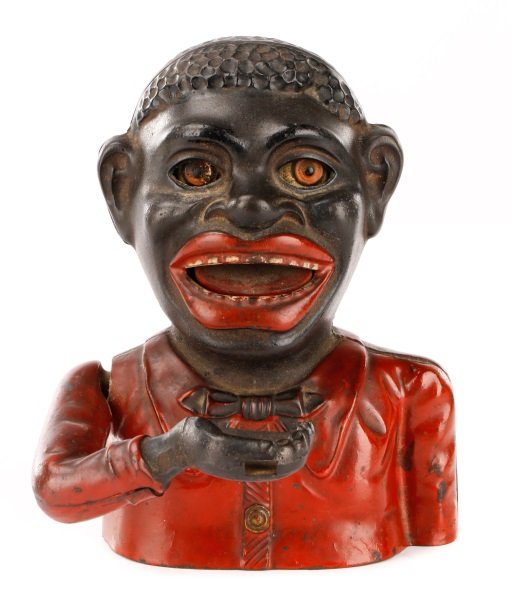 English Painted Cast Iron Jolly Negro Bank: English, late 19th/ early 20th century. A polychromed cast iron "Jolly Nigger" mechanical bank depicting a caricaturIzed black man at bust length with truncated proper left arm and right arm bent at e